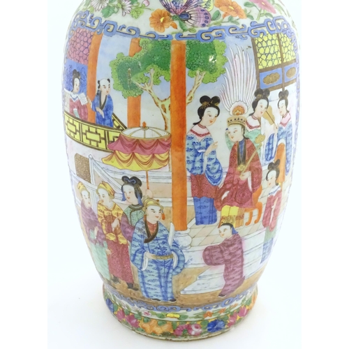 66 - A large Chinese / Cantonese famille rose baluster vase with a flared rim decorated with panels depic... 
