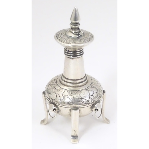 504 - A white metal scent bottle with engraved decoration formed as a stylised pagoda building on four fee... 