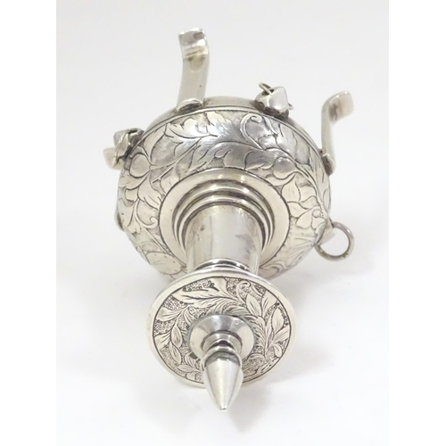 504 - A white metal scent bottle with engraved decoration formed as a stylised pagoda building on four fee... 