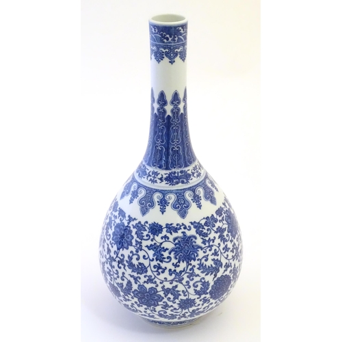 2 - A Chinese blue and white bottle vase decorated with scrolling flowers and foliage, the neck with ban... 