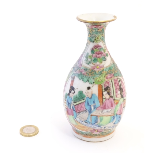 25 - A Cantonese famille rose bottle vase with a flared rim decorated with figures on a terrace with a bo... 