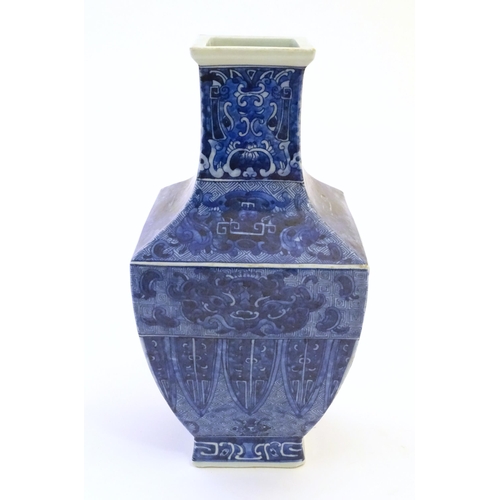 3 - A Chinese blue and white vase of squared form decorated with stylised masks, banded detail and scrol... 