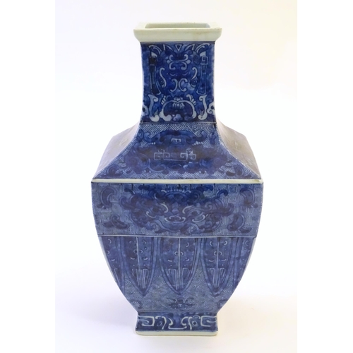 3 - A Chinese blue and white vase of squared form decorated with stylised masks, banded detail and scrol... 