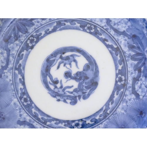 30 - Three Chinese blue and white dishes, to include a dish decorated with underwater scenes with fish am... 