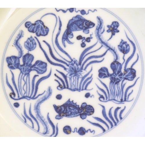 30 - Three Chinese blue and white dishes, to include a dish decorated with underwater scenes with fish am... 