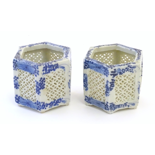 44 - Two Chinese pot pourri holders of hexagonal form with blue and white foliate decoration and reticula... 