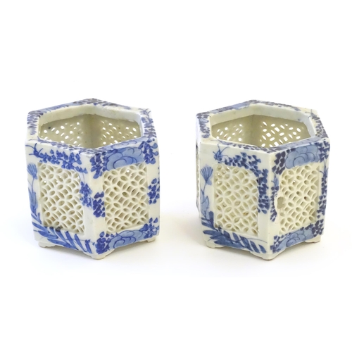 44 - Two Chinese pot pourri holders of hexagonal form with blue and white foliate decoration and reticula... 
