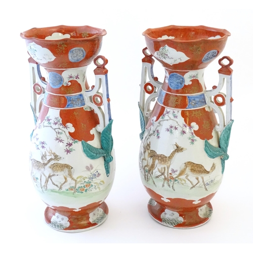 65 - A pair of Japanese vases with flared scallop edge rims and twin pierced handles with relief foliate ... 