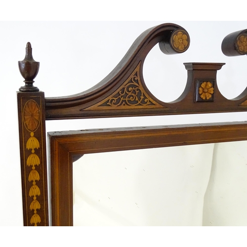 2044 - A late 19thC mahogany cheval mirror having a swan neck pediment with blind fretwork carving and flan... 