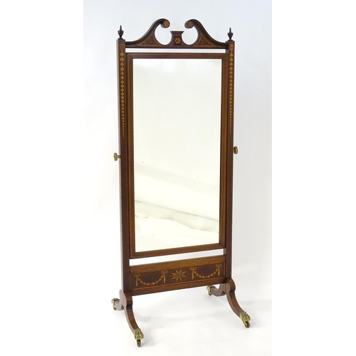 2044 - A late 19thC mahogany cheval mirror having a swan neck pediment with blind fretwork carving and flan... 