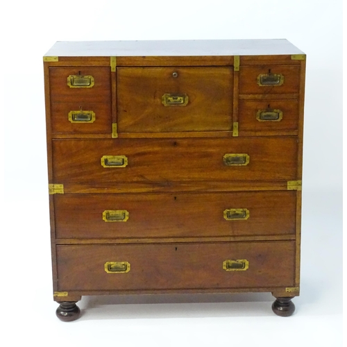 1937 - An early / mid 19thC mahogany campaign chest with brass caps and corner mounts, the chest comprising... 