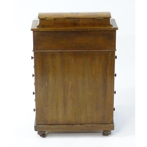1958 - A late 19thC walnut Davenport surmounted by a fitted section with pigeon holes above an inset leathe... 