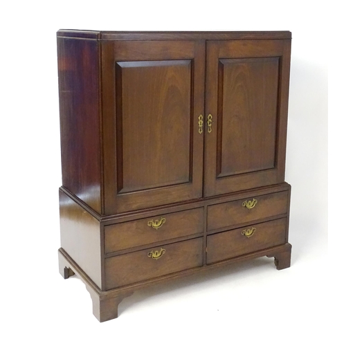1939 - A mid 18thC mahogany dwarf press having  a rectangular top with re-entrant corners above two panelle... 