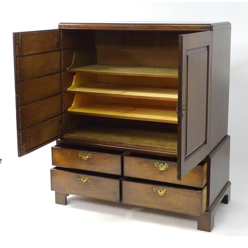 1939 - A mid 18thC mahogany dwarf press having  a rectangular top with re-entrant corners above two panelle... 