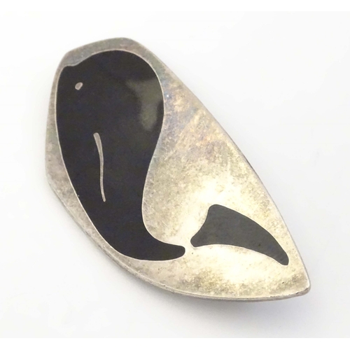 675 - Scandinavian Jewellery: A Danish silver brooch with black enamel whale decoration, marked Meka, Ster... 