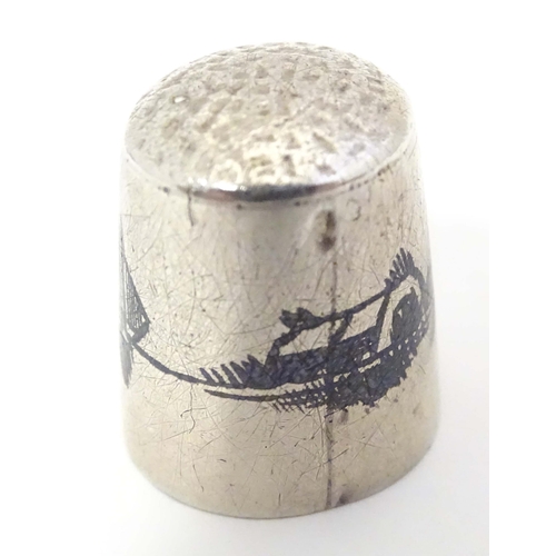 501 - A white metal thimble with niello decoration depicting a river Nile landscape with boats.