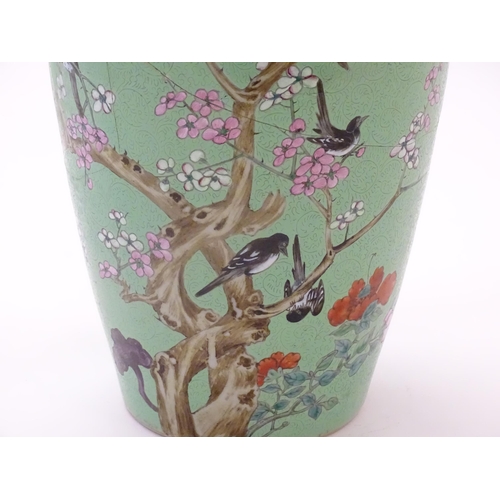 40 - A Chinese vase with incised detail to the pale green ground, decorated with birds in a tree with blo... 