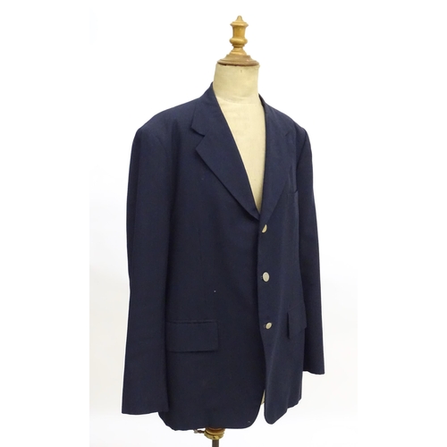 28 - A navy blue bespoke suit with tapered trousers and metal button detail by 'Sam's Tailor' based in Ho... 