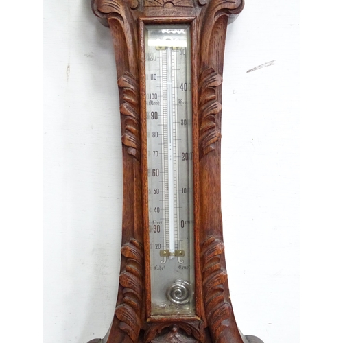 23 - An aneroid barometer by A Franks of Manchester. Approx. 34