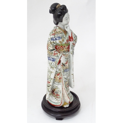 25 - A ceramic figure modelled as a Japanese lady. Approx. 17