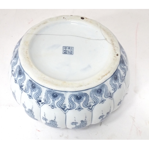 31 - A Chinese blue and white pot and cover of stylised gourd / pumpkin form decorated with banded vine a... 