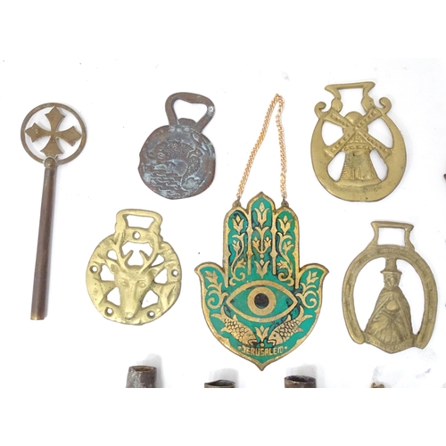 32 - A box of assorted brass items to include a bottle opener, horse brasses, a Hamsa hand with enamel an... 