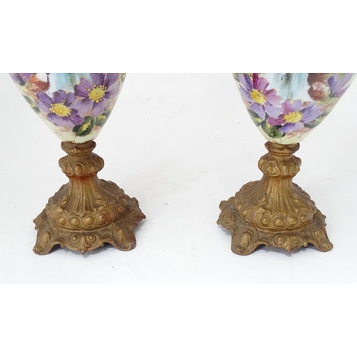 33 - A pair of hand painted glass ewers with gilt metal mounts. Approx. 21