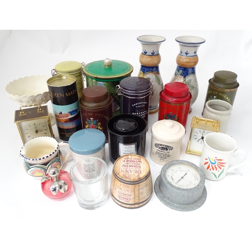 34 - A box of miscellaneous items to include tins, ceramics, clocks, etc.