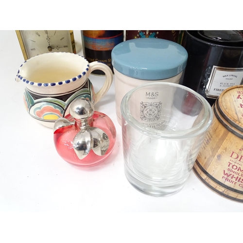34 - A box of miscellaneous items to include tins, ceramics, clocks, etc.
