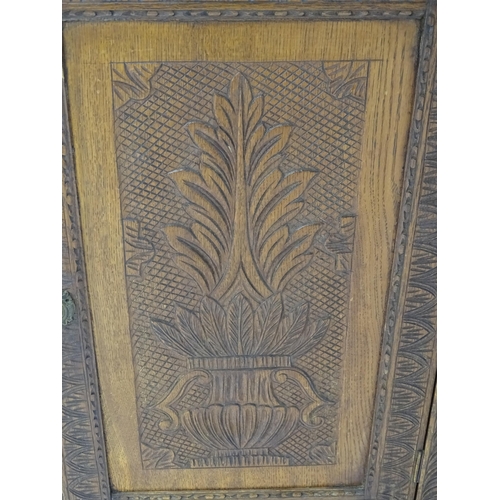 39 - A 19thC mahogany corner cupboard with carved decoration. Approx. 30 1/2