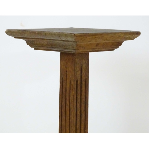 43 - An oak jardiniere stand with squared top and fluted column. Approx. 36