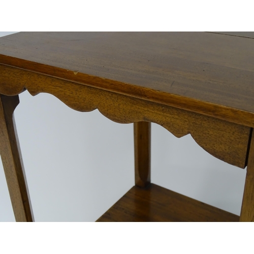 59 - A 19thC mahogany two tier table with single drawer. Approx. 30