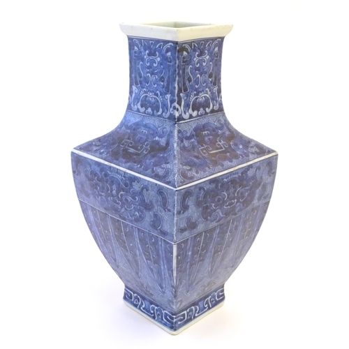 8 - A Chinese blue and white vase of squared form decorated with stylised masks, banded detail and scrol... 