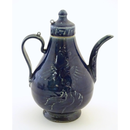 17 - A Chinese pear shaped teapot with phoenix bird decoration to body. Approx. 8 3/4