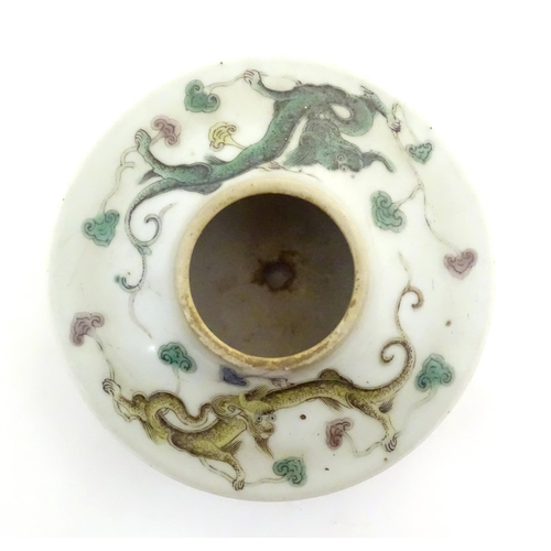 19 - A Chinese brush wash of circular form decorated with dragons amongst stylised clouds. Character mark... 