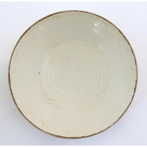 24 - A Chinese Ding style plate with relief fish decoration. Approx. 8