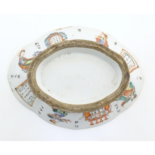 27 - A Chinese footed bowl of lozenge form decorated with figures, vases and Character marks / script. Ap... 