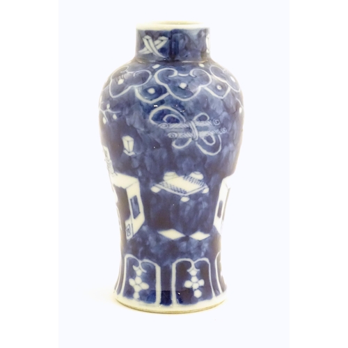 13 - A small Chinese blue and white vase decorated with flowers in a vase and banded borders. Character m... 