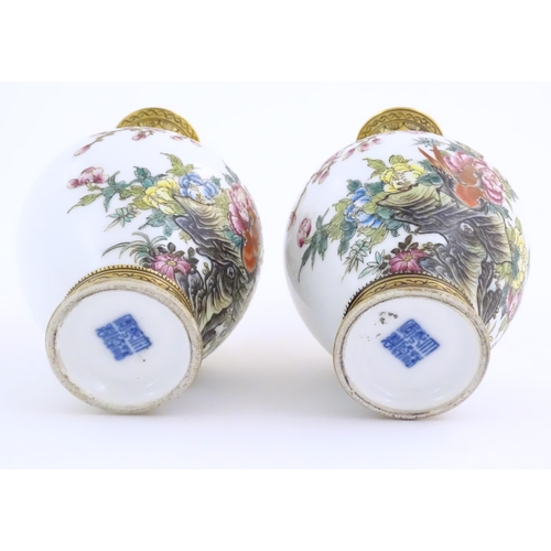 3 - A pair of Chinese vases decorated with birds, flowers and blossom trees, with gilt detail to necks a... 