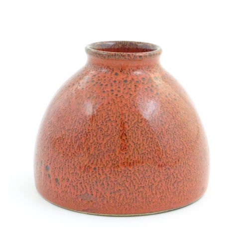 31 - A Chinese water pot with a red glaze. Character marks under. Approx. 4