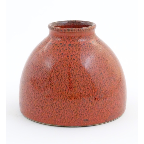 31 - A Chinese water pot with a red glaze. Character marks under. Approx. 4