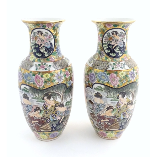 55 - A pair of Japanese vases of baluster form with panelled decoration depicting ladies by a river borde... 