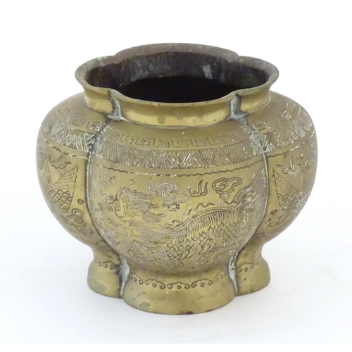 787 - A Chinese brass lobed pot decorated with dragons, phoenix birds and pagoda buildings. Character mark... 