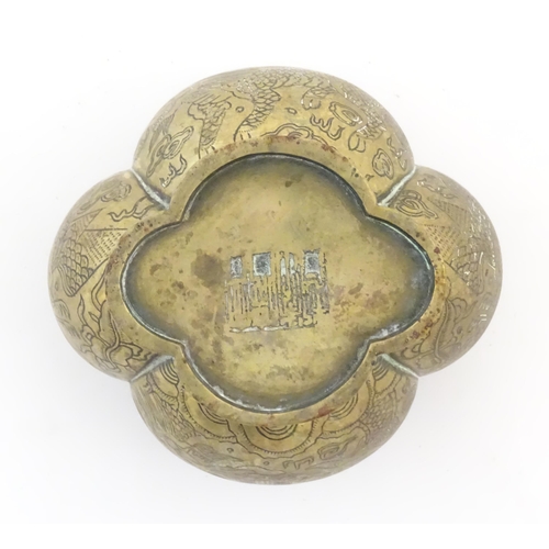 787 - A Chinese brass lobed pot decorated with dragons, phoenix birds and pagoda buildings. Character mark... 