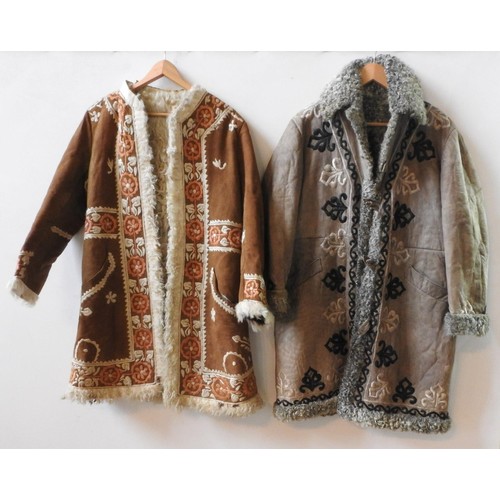 TWO VINTAGE AFGHAN SUEDE JACKETS WITH WOOL FLEECE LINING, one grey and one tan, both with decorative embroidered detailing.