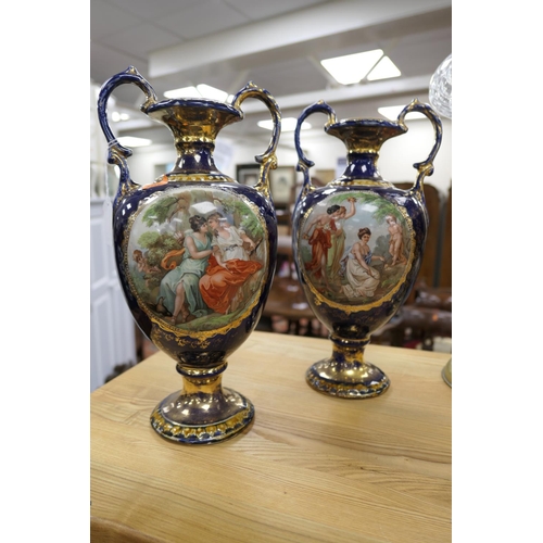 166 - Pair of blue ground twin handled continental vases overprinted with cherub scenes