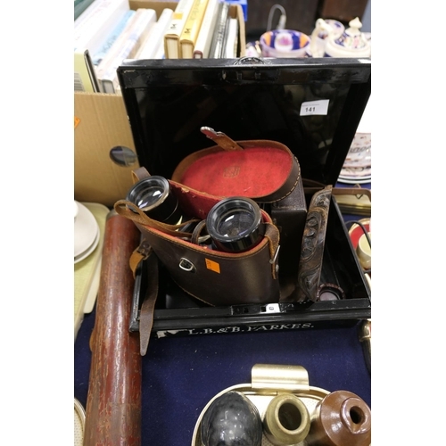 141 - Black metal strong box, pair of Prinz binoculars, cased, camera, hardwood stands; also a G. Dixey, L... 