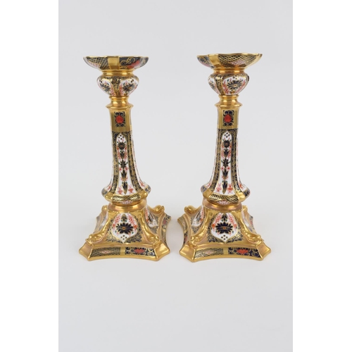 45 - Pair of Royal Crown Derby china candlesticks, pattern no. 1128, in old imari colours, height 27cm