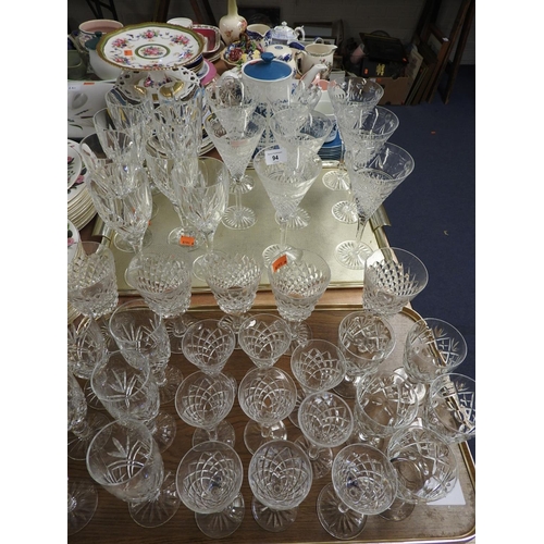 94 - Assorted quality cut glass wines and champagne flutes including Waterford and Stuart (2 trays)