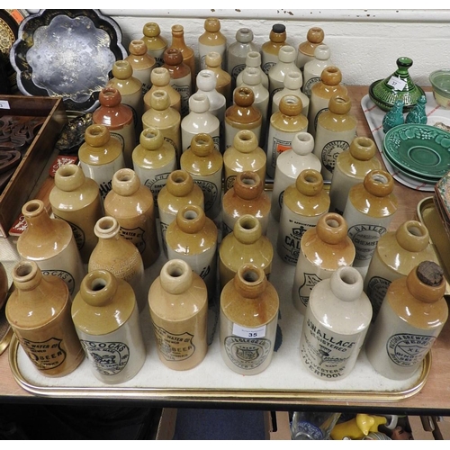 35 - Collection of named salt glazed stoneware ginger beer and water bottles including local interest Che... 